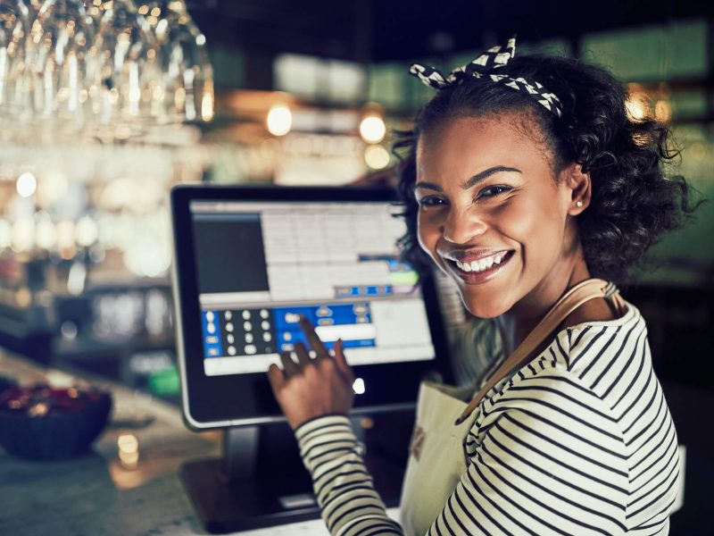 smiling-african-waitress-using-a-restaurant-point-of-sale-terminal-1.jpg